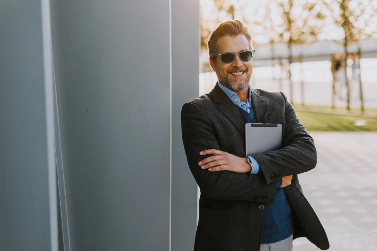 Business professional holding a tablet outdoors