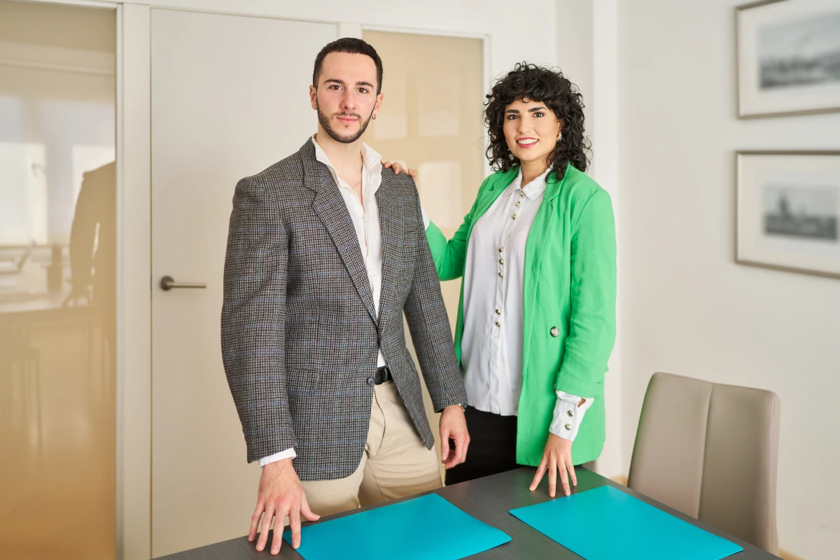 Two business professionals standing together in a modern office