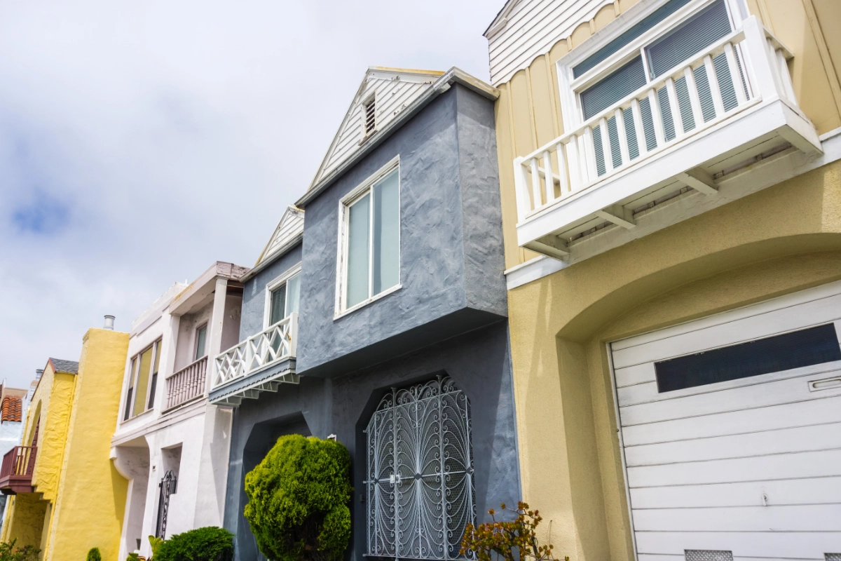 Row of colourful residential houses with balconies and garages