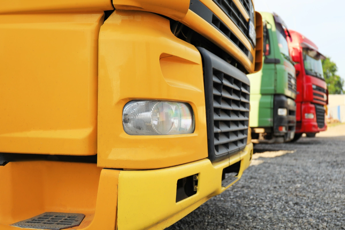 Colourful HGV lorries parked in a row at a commercial