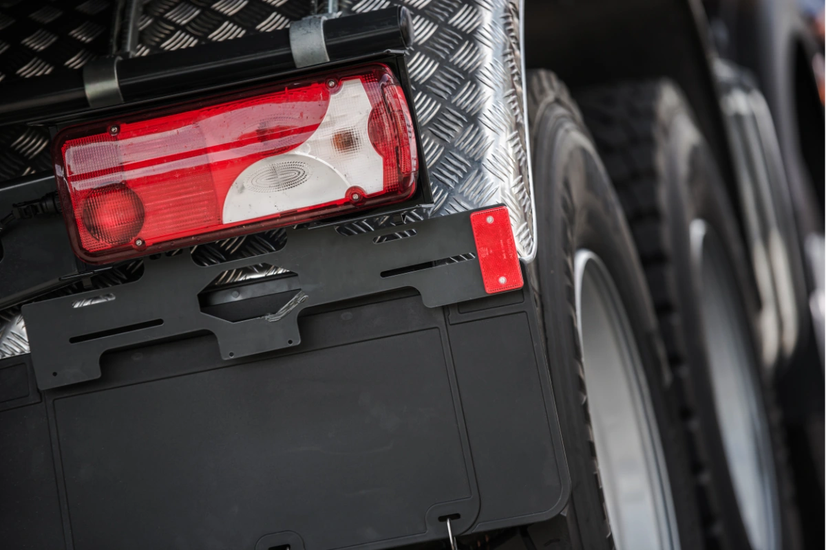 Close-up of a commercial truck rear light and wheels