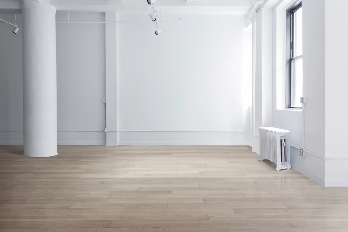 Bright empty commercial unit with wooden flooring and large windows