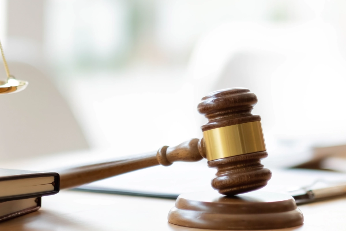 Scales of justice and judge’s gavel on a legal office desk