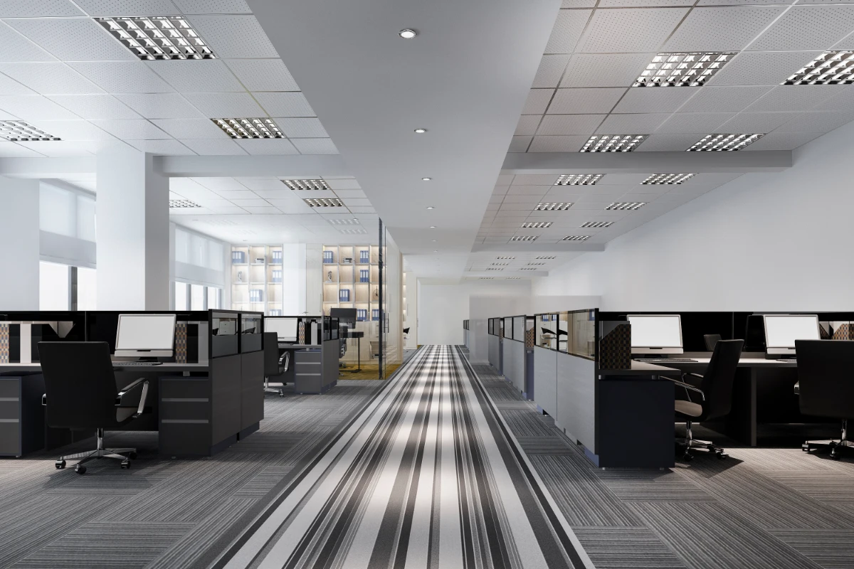 Modern open-plan office interior with rows of workstations and computers