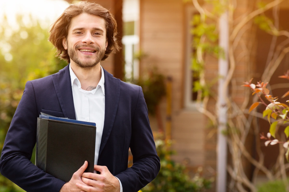 Property professional holding documents outside a residential property