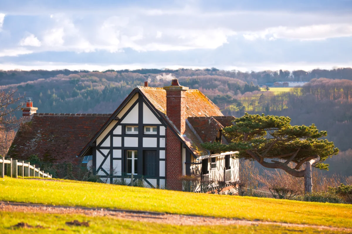 Traditional timber-framed country house set within rolling countryside