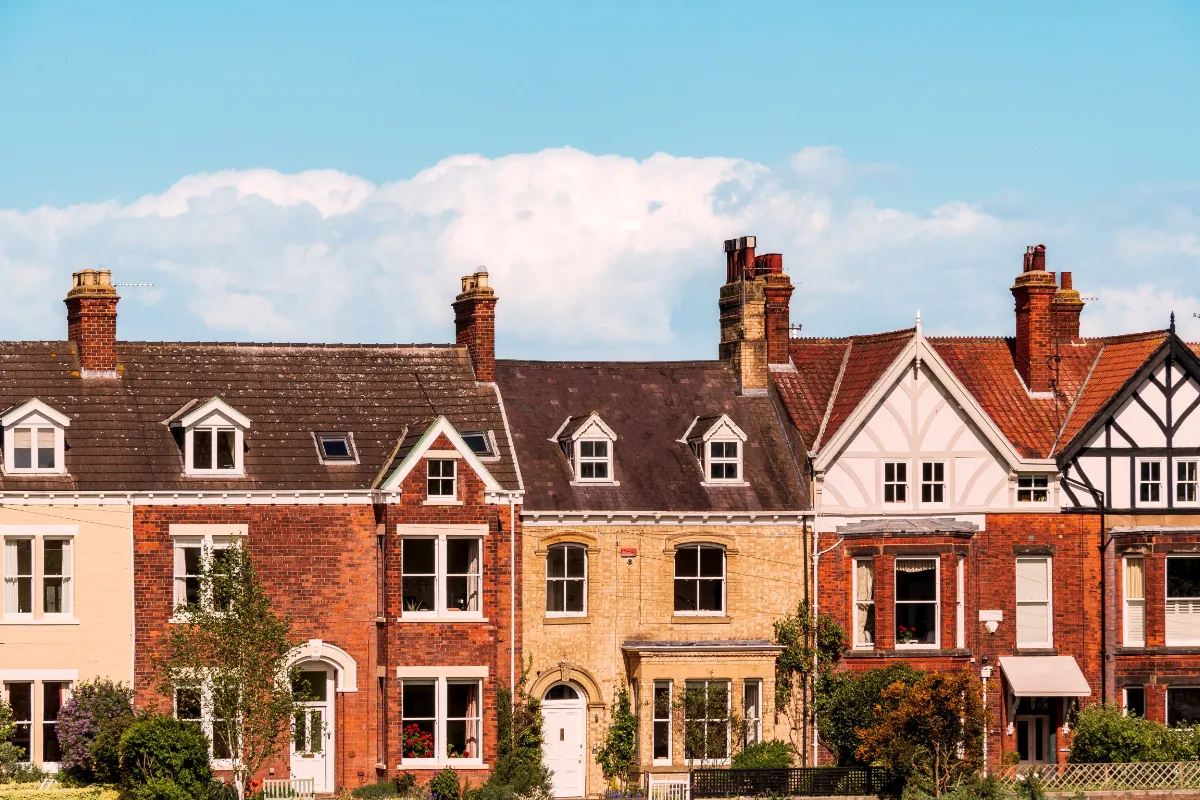 Row of traditional brick residential houses under a blue sky