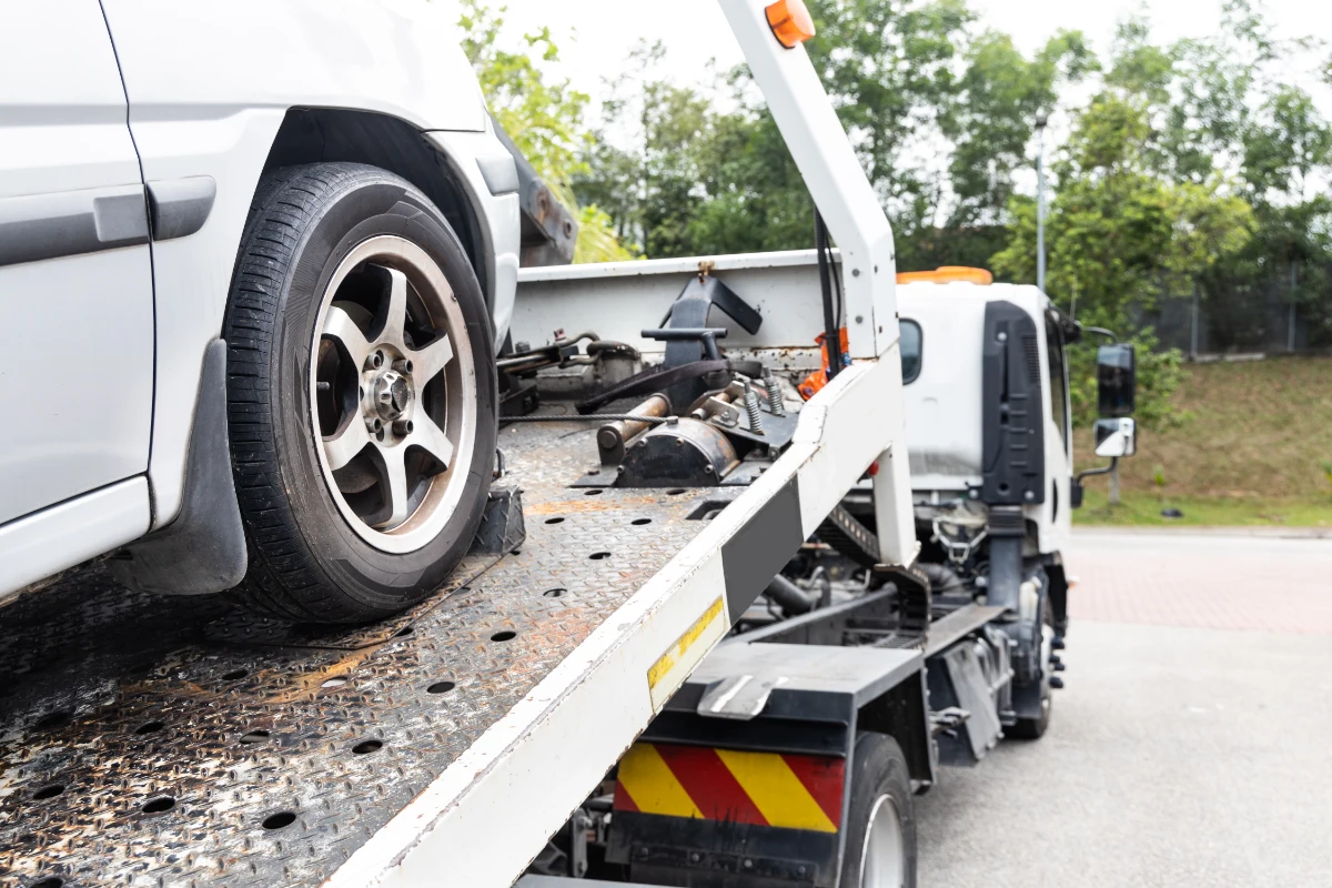 Car being transported on the back of a recovery truck